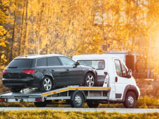 roadside-assistance-service-country-road-tow-truck-is-carrying-car-that-has-been-involved-traffic-accident-has-broken-engine-2048×1366-1